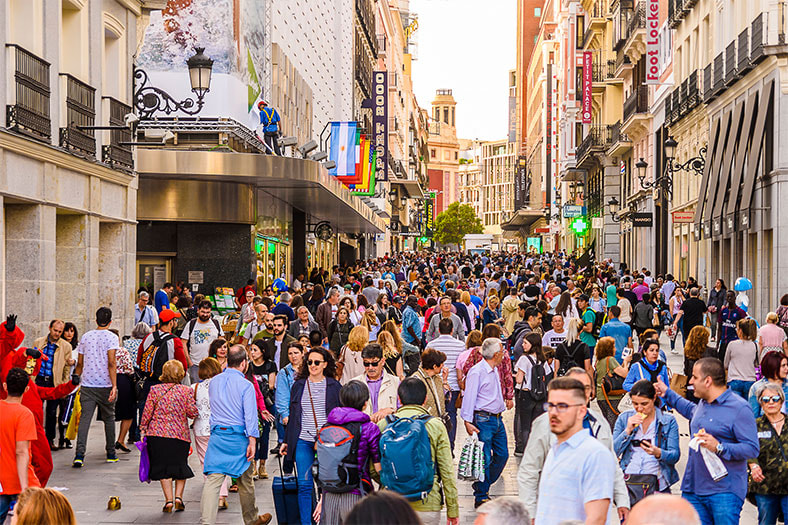 Personas caminando y de compras en la calle Preciados de Madrid, famosa zona comercial de la capital española.