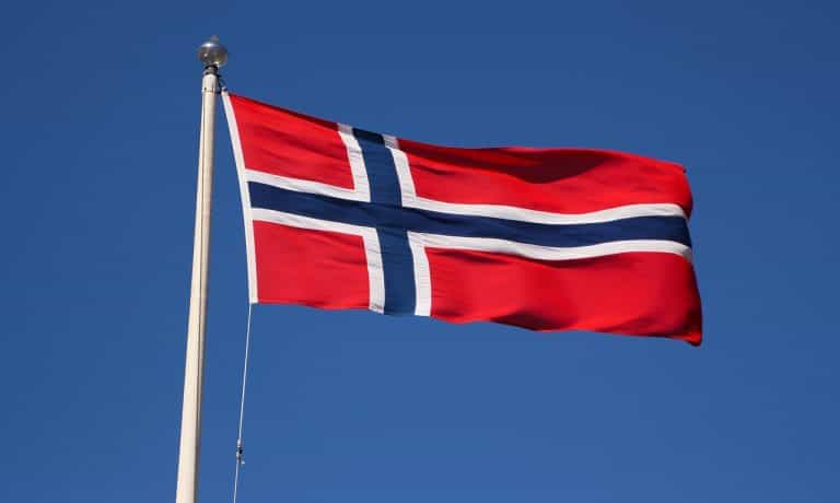 Bandera de Noruega ondeando desde un mástil.