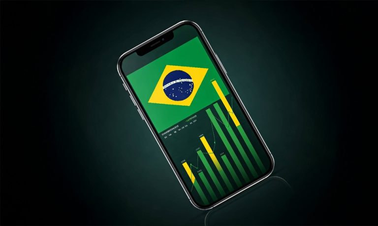 Teléfono móvil con índices de crecimiento y la bandera de Brasil.