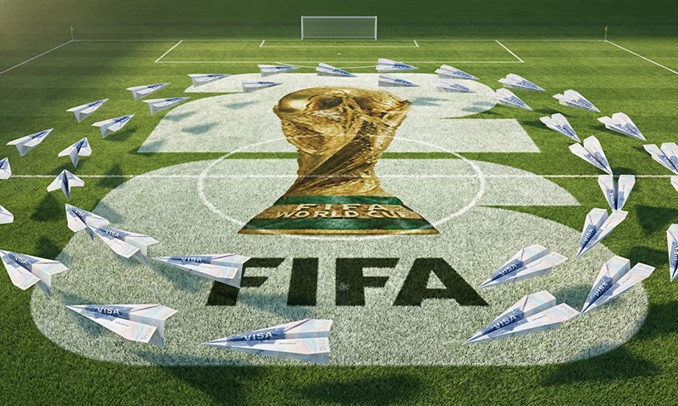 Trofeo del Mundial y logotipo de la FIFA en un campo de fútbol.