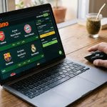 Portátil con web de apuestas deportivas abierta y mano usando ratón